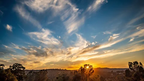White Wispy Clouds and Yellow Sunset Fades to Dark Time Lapse Stock Footage 281315052