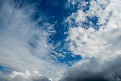 White Wispy Cumulus Clouds In Vibrant Blue Sky Stock Photos