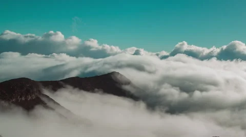 White Wispy Time-Lapse Clouds Breathing Along Mountainside Stock Footage 66004931