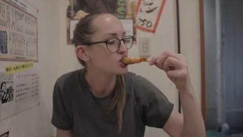 White woman dips and eats tempura excitedly Video stock 230707925