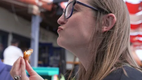 White woman eats fried fish slow motion Stock Footage 157791300