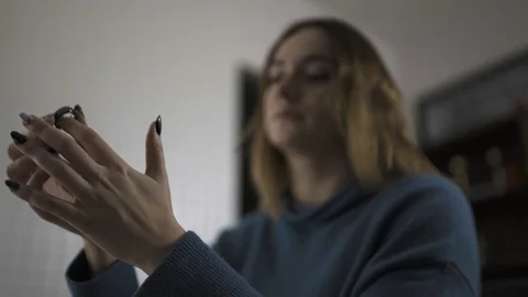 White woman puting smart ring on finger, configuring with phone after. Stock Footage 125302649