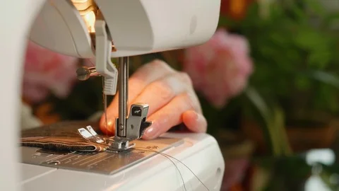 White woman's hands sew on electrical sewing machine. Close up view Stock Footage 115631143