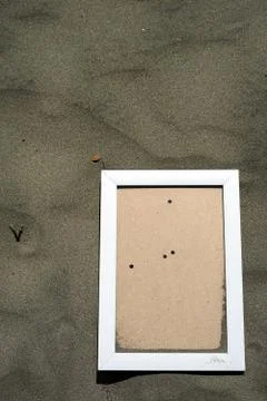 White Wooden Blank photo frames on beach sand Stock Photos