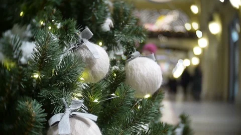 White wool balls and lights. New Year's and abstract blurred shopping mall Video stock 70650014