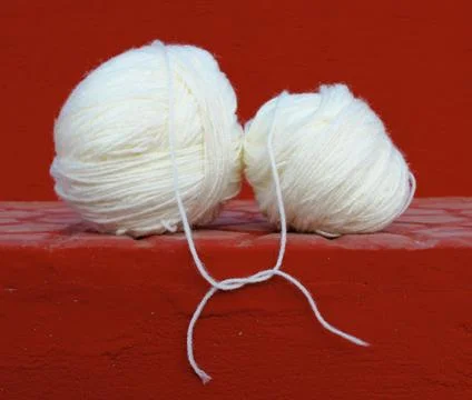 White wool balls tied up on red background Stock Photos