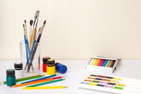 On a white worktop table with drawing supplies and brushes Stock Photos
