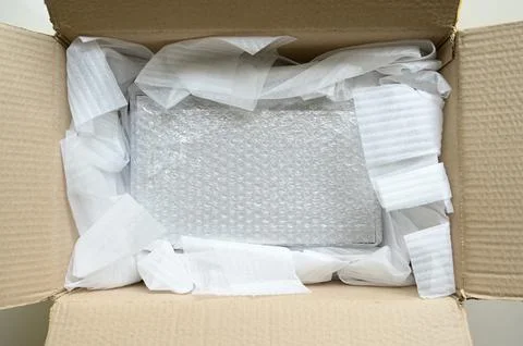 White wrap bubble put in brown box Stock Photos