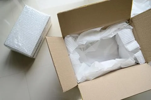 White wrap bubble put in brown box Stock Photos