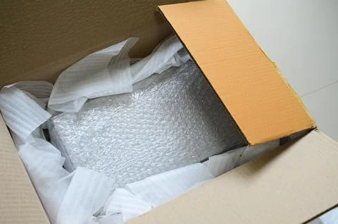 White wrap bubble put in brown box Stock Photos