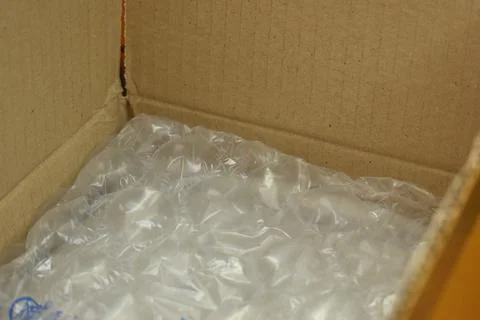 White wrap bubble put in brown box Stock Photos