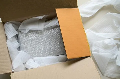 White wrap bubble put in brown box Stock Photos