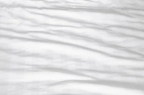 White wrinkled bedding sheet with pattern after guest's use taken in hotel .. Stock Photos