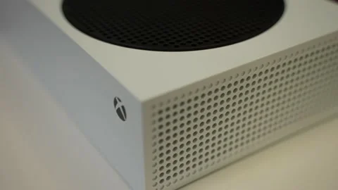 A white Xbox one on top a turn table slowly moving Stock Footage 158735627