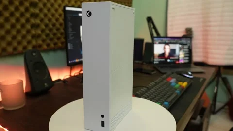 A white Xbox series s console on top a turn table slowly moving on wooden table Stock Footage 158735670