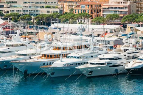 White Yachts Of Different Sizes Are Moored At City Pier, Jetty I Stock Photos
