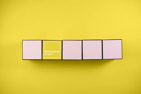 White yellow cube on yellow background Stock Photos