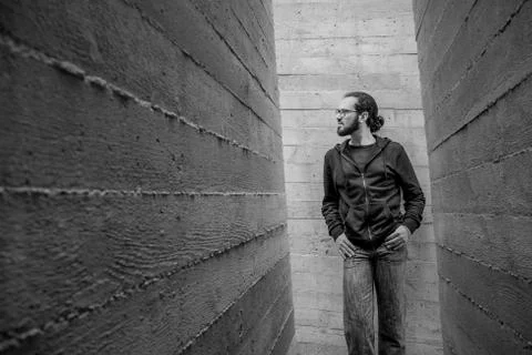 White young handsome man standing near the wall and look up. Portrait of fash Stock Photos