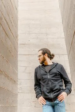 White young handsome man standing near the wall and look up. Portrait of fash Stock Photos