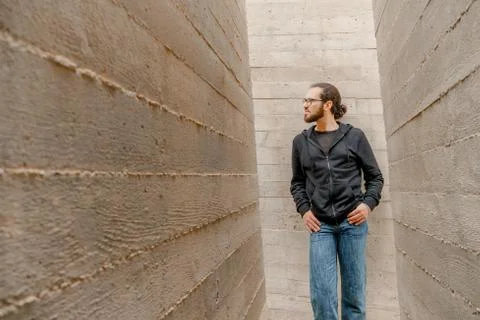 White young handsome man standing near the wall and look up. Portrait of fash Stock Photos