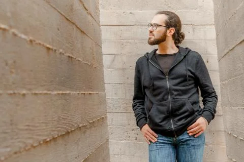 White young handsome man standing near the wall and look up. Portrait of fash Stock Photos
