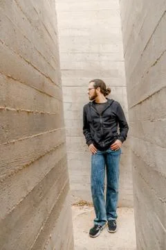 White young handsome man standing near the wall and look up. Portrait of fash Stock Photos