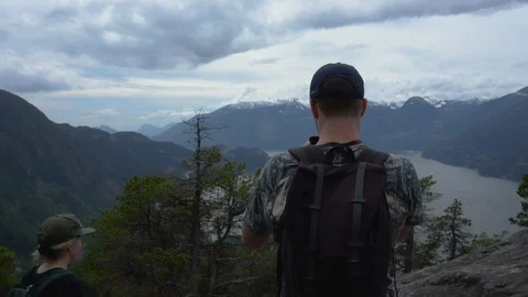 White young male using cell phone to record mountains after accomplishing Stock Footage 111332038