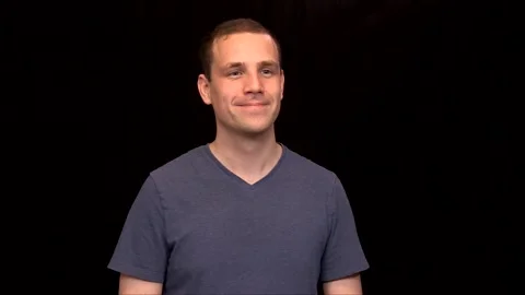 A white young Man on black background is nodding and smiling Vidéo 146263648