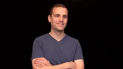 A white young Man on black background crosses his arms pleased Vidéo 146263656