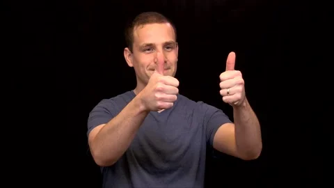 A white young Man on black background puts 2 thumbs up Vidéo 146263659