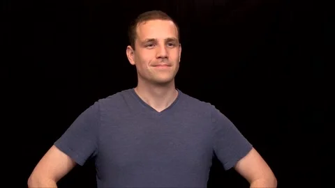 A white young Man on black background puts arms on hips nodding Vidéo 146263663
