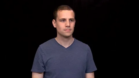 A white young Man on black background puts a thumb down shaking his head Vidéo 146263673