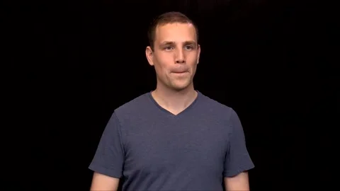 A white young Man on black background points either side of him Vidéo 146263698