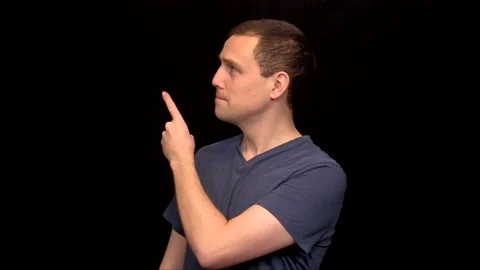 A white young Man on black background points then puts a thumb up Vidéo 146263709