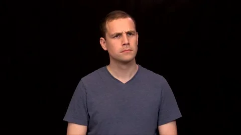 A white young Man on black background is nodding interested Vidéo 146263715
