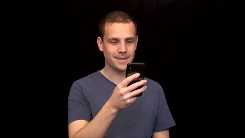 White young Man is scrolling on his phone and is disappointed Vidéo 146263587