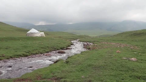 White yurt among green fields and rivers Video stock 250551646