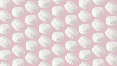 White zephyr marshmallows pattern on light pastel pink background Stock Photos