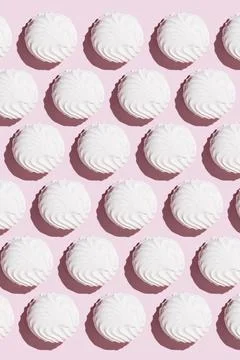 White zephyr pattern on light pink table background in hard light. Pastel col Stock-Fotos