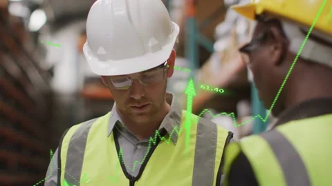 Whitehat supervisor studying green data overlays in warehouse as colleague Stock Footage 334321884