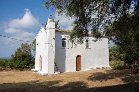 Whitewashed chapel in rural setting under a sunny sky. Stock Photos