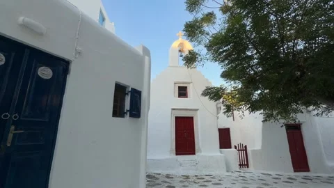 Whitewashed Cobblestone Square Mykonos - Church and Blue Door Stock Footage 346736062