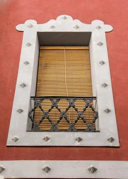 Whitewashed facade with window with forged metal grill Stock Photos