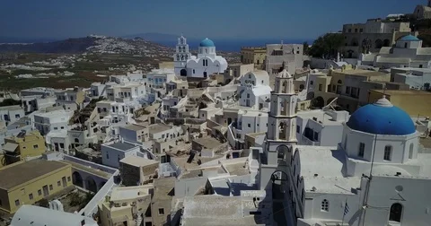 Whitewashed hilltop village with blue domes on Santorini Stock-Footage 75978464