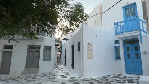 Whitewashed Street with Blue Door and Balcony Mykonos Greece Stock Footage 346716270