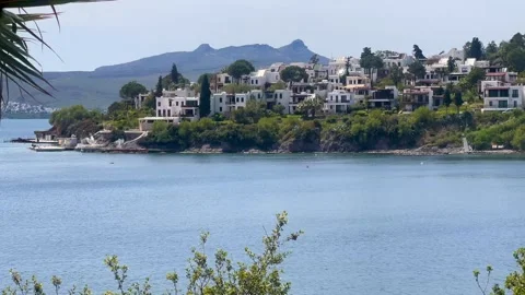 Whitewashed villas line a rocky peninsula above the Aegean sea near Bodrum, Stock Footage 310320904