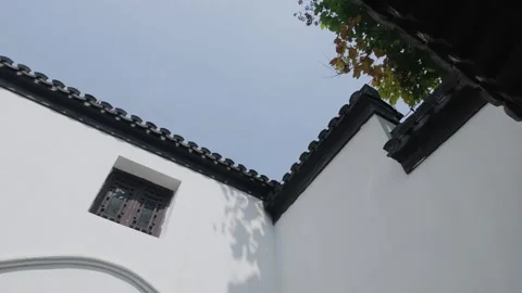 Whitewashed Wall With Small Wooden Window Under Grey Roof Tiles Stock Footage 346385473