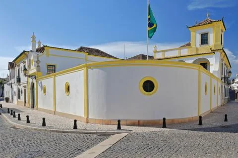 Whitewashed wall-yellow edge line-Brazilian consulate wall and flag. Faro-PT Stock Photos
