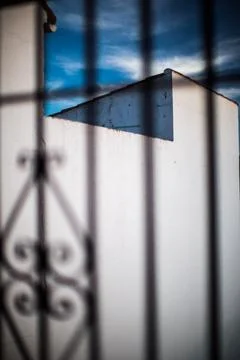 Whitewashed Walls Viewed Through Wrought Iron Gate in Villaviciosa de Cordo.. Stock Photos