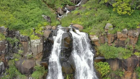 Whitewater dropping over a rock ledge in a Kauai valley Vídeos de archivo 96046024